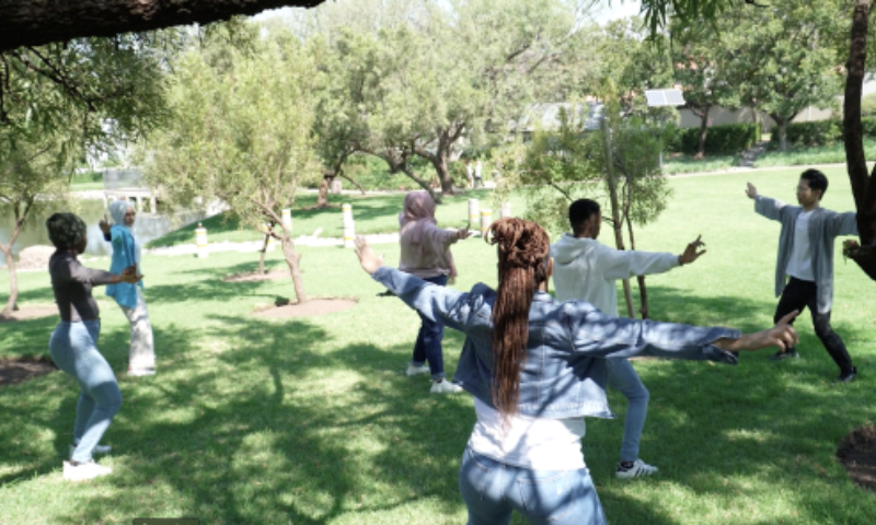 hu zijing practices baduanjin with his students at the university of johannesburg. photo:courtesy of hu zijing